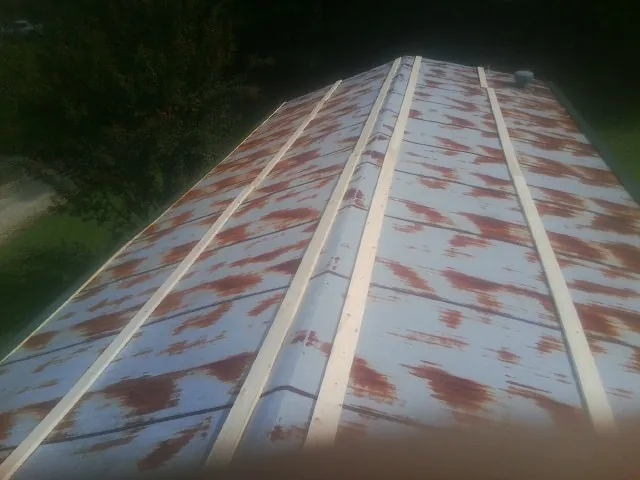 Rusted metal roof panels with new wood purlins before replacement — Storm Damage Roof Repair in Haubstadt by Roofing Brothers